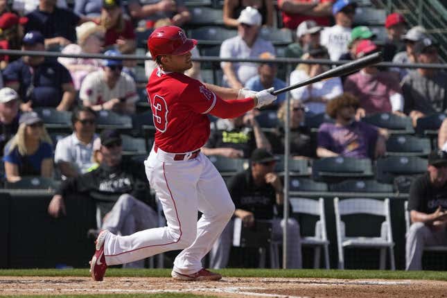 Mar 8, 2023; Tempe, Arizona, USA; Los Angeles Angels catcher Max Stassi (33) hits a single against the Colorado Rockies in the fourth inning at Tempe Diablo Stadium.