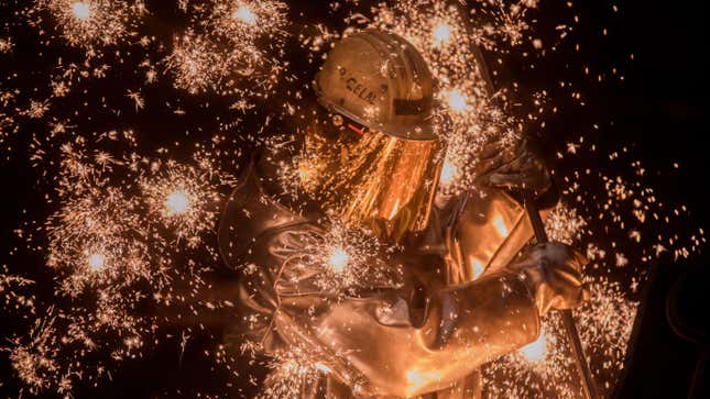 Sparks fly as a worker takes a sample of molten iron flowing from a blast furnace at the Thyssenkrupp Steel Europe steelworks in Germany.