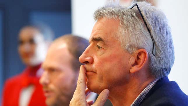 Ryanair Chief Executive Michael O'Leary covers his mouth at a press conference.