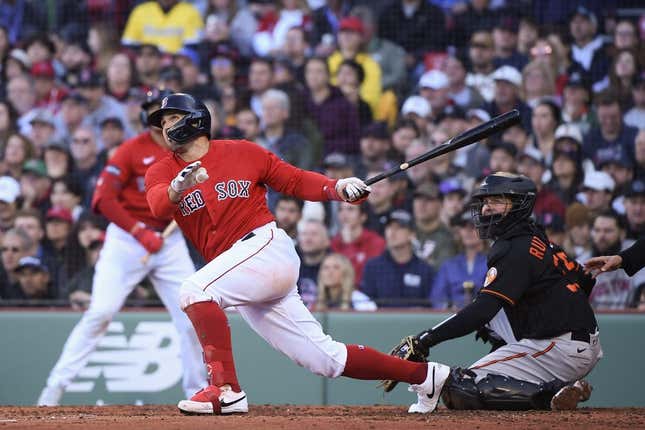 Apr 1, 2023; Boston, Massachusetts, USA;  Boston Red Sox center fielder Adam Duvall (18) hits a two-run home run during the third inning against the Baltimore Orioles at Fenway Park.
