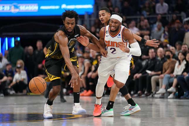 Jan 10, 2023; San Francisco, California, USA; Golden State Warriors forward Andrew Wiggins (22) knocks the ball out of the hands of Phoenix Suns guard Josh Okogie (2) in the fourth quarter at the Chase Center.
