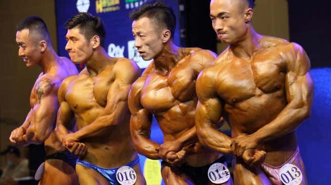 Bodybuilders flexing onstage at competition