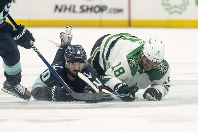 May 13, 2023; Seattle, Washington, USA; Seattle Kraken forward Matty Beniers (10) and Dallas Stars forward Max Domi (18) dive for a loose puck during the second period in game six of the second round of the 2023 Stanley Cup Playoffs at Climate Pledge Arena.