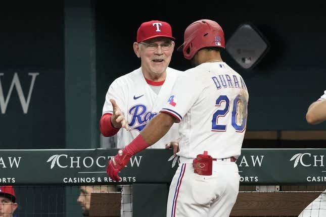 Apr 29, 2023; Arlington, Texas, USA; Texas Rangers shortstop Ezequiel Duran (20) celebrates his two-run home run with manager Bruce Bochy (15) against the New York Yankees during the fifth inning at Globe Life Field.