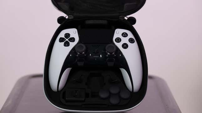 A DualSense Edge is shown in its carrying case, with its replaceable analog sticks, charging connector, and back paddles also on display at the bottom.