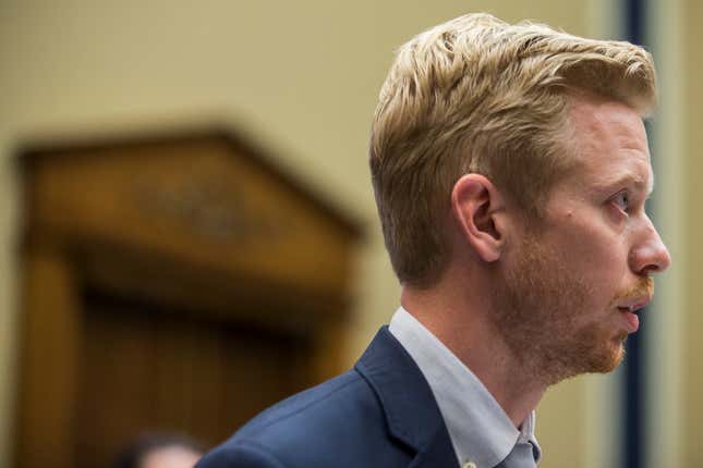 Reddit CEO Steve Huffman in a suit staring off to the side of the frame