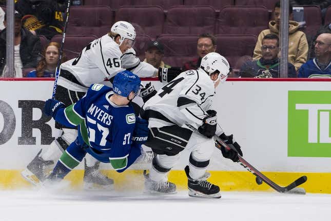 Apr 2, 2023; Vancouver, British Columbia, CAN; Los Angeles Kings forward Blake Lizotte (46) and forward Arthur Kaliyev (34) check Vancouver Canucks defenseman Tyler Myers (57) in the second period at Rogers Arena.