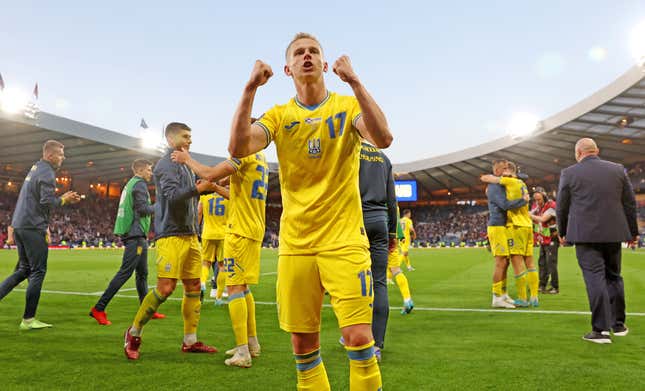 Ukraine’s Oleksandr Zinchenko celebrates win over Scotland, as embattled country is one win away from 2022 World Cup.
