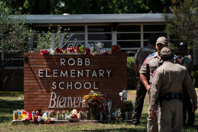 Flowers and candles are placed outside Robb Elementary School in Uvalde, Texas, Wednesday, May 25, 2022, to honor the victims killed in Tuesday’s shooting at the school. Desperation turned to heart-wrenching sorrow for families of grade schoolers killed after an 18-year-old gunman barricaded himself in their Texas classroom and began shooting, killing several fourth-graders and their teachers.