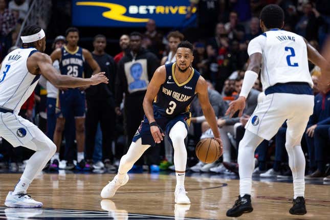 Mar 8, 2023; New Orleans, Louisiana, USA;  New Orleans Pelicans guard CJ McCollum (3) brings the ball up court against Dallas Mavericks guard Kyrie Irving (2) and guard Jaden Hardy (3) during the second half at Smoothie King Center.