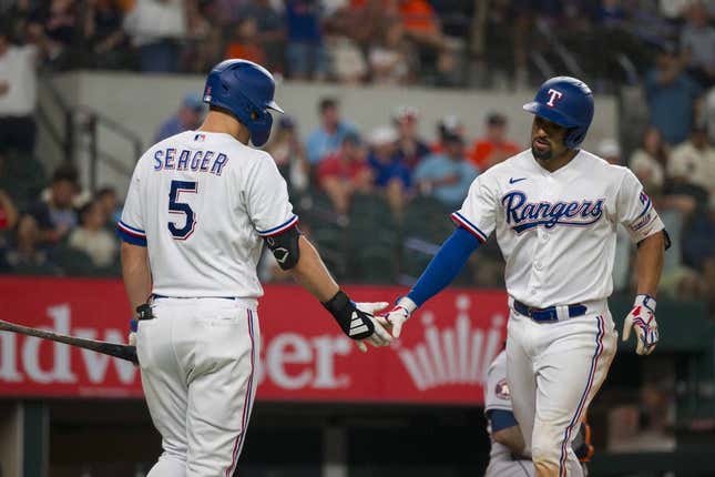 Sep 6, 2023; Arlington, Texas, USA; Texas Rangers shortstop Corey Seager (5) and second baseman Marcus Semien (2) celebrate after Semien hits a home run against the Houston Astros at Globe Life Field.