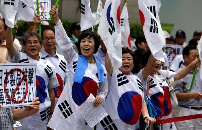 Korean protesters shout slogans during a rally in front of the Japanese Embassy