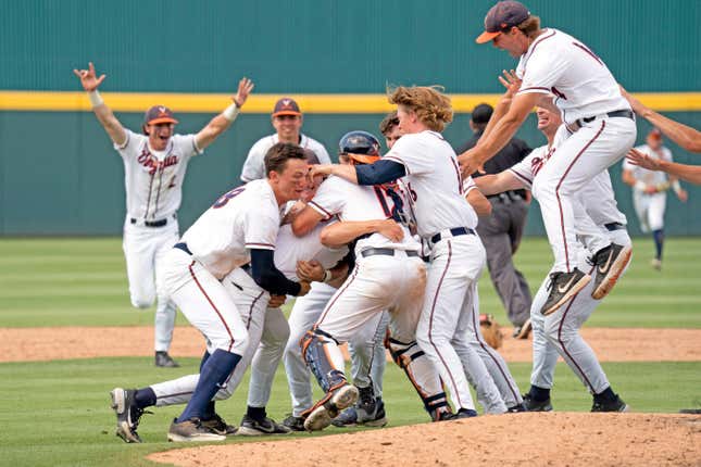 University of Virginia players crowd the mound in celebration.