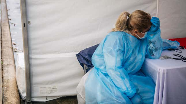 A medical assistant rests while waiting for patients at an abandoned Dave & Buster’s that’s been converted to a large-scale covid-19 testing facility on January 8, 2022 in Houston, Texas.