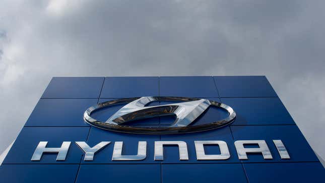A photo of the Hyundai logo above a dealer. 