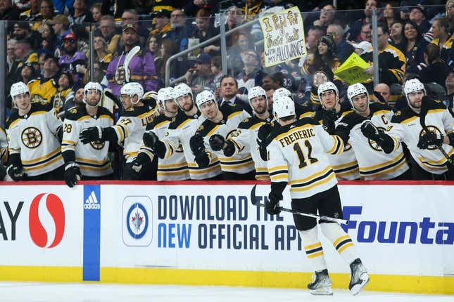 Mar 16, 2023; Winnipeg, Manitoba, CAN;  Boston Bruins forward Trent Frederic (11) is congratulated by his teammates after scoring against the Winnipeg Jets during the first period at Canada Life Centre.