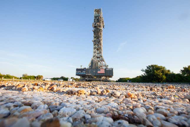 A rocket road will carry the rocket and spacecraft (in background) to the launchpad.
