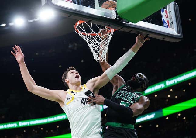 Mar 31, 2023; Boston, Massachusetts, USA; Boston Celtics guard Jaylen Brown (7) makes the basket against Utah Jazz center Walker Kessler (24) in the second quarter at TD Garden.