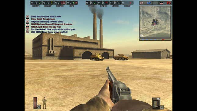 A soldier points a gun at some tanks in front of a factory in Battlefield 1942, one of the best games of 2002.