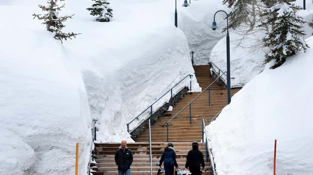People walk up stairs framed by snow in Mammoth Lakes, CA.