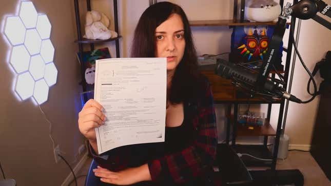 Holding a copy of the search warrant in her right hand, trans streamer Clara "Keffals" Sorrenti details the trauma Ontario police inflicted on her during a recent swatting incident.