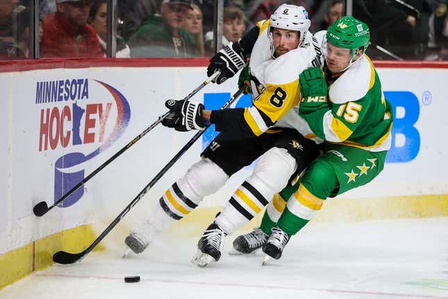 Nov 17, 2022; Saint Paul, Minnesota, USA; Minnesota Wild center Mason Shaw (15) and Pittsburgh Penguins defenseman Brian Dumoulin (8) battle for the puck during the second period at Xcel Energy Center.