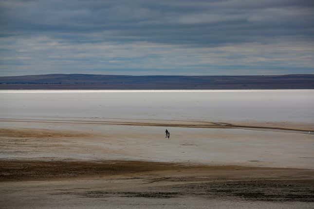 A man walks along Lake Tuz, Monday, Oct. 25, 2021.
