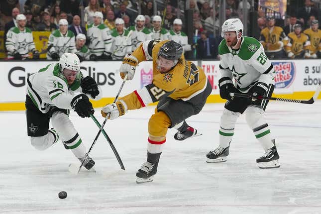May 19, 2023; Las Vegas, Nevada, USA; Vegas Golden Knights center Brett Howden (21) shoots the puck past Dallas Stars center Radek Faksa (12) and defenseman Ryan Suter (20) during the first period in game one of the Western Conference Finals of the 2023 Stanley Cup Playoffs at T-Mobile Arena.