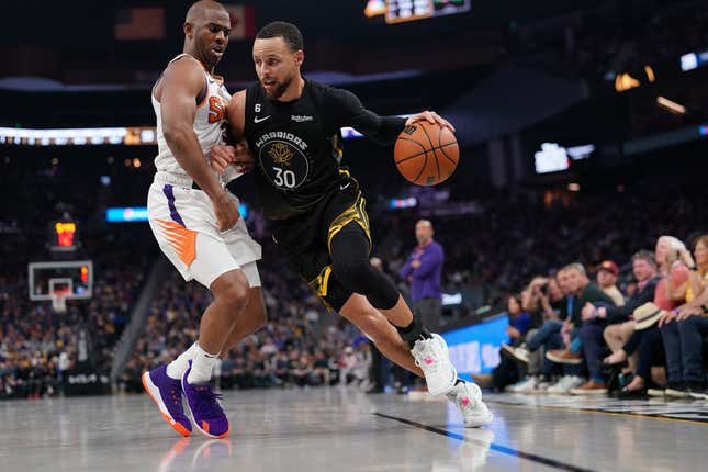 Mar 13, 2023; San Francisco, California, USA; Golden State Warriors guard Stephen Curry (30) dribbles the ball next to Phoenix Suns guard Chris Paul (3) in the second quarter at the Chase Center.
