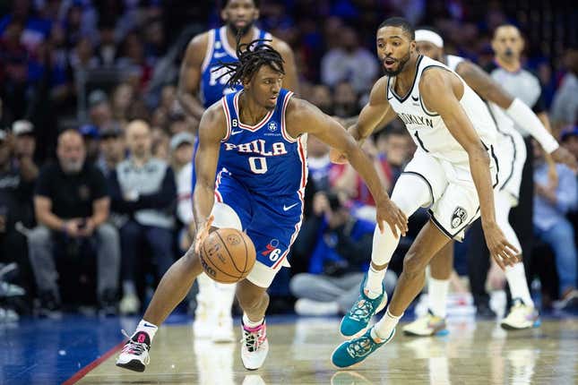 Apr 17, 2023; Philadelphia, Pennsylvania, USA; Philadelphia 76ers guard Tyrese Maxey (0) dribbles the ball  in front of Brooklyn Nets forward Mikal Bridges (1) during the second quarter in game two of the 2023 NBA playoffs at Wells Fargo Center.