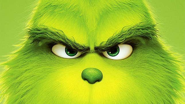 The Grinch's face, close-up, on a green background.
