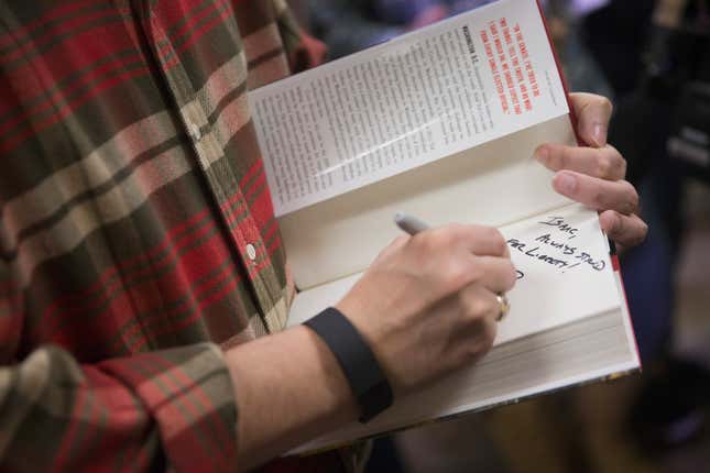Sen. Ted Cruz (R-Texas) autographs a book for a supporter during a campaign event at CrossRoads Shooting Sports gun shop and range on December 4, 2015 in Johnston, Iowa.