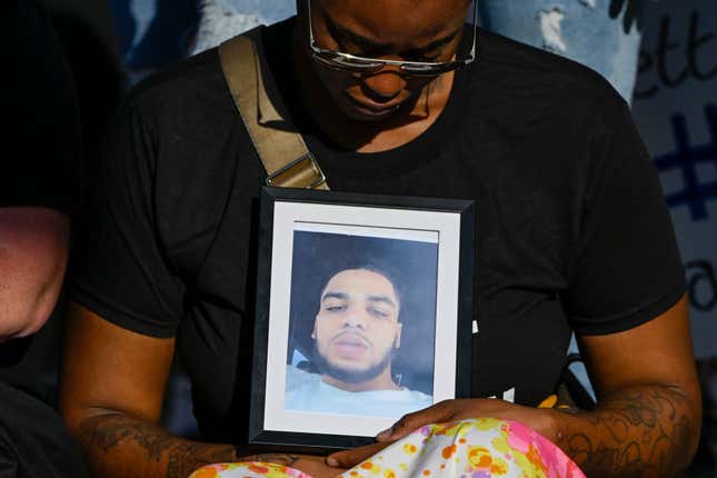 The girlfriend of Donovan Lewis holds a picture of him during a rally at the Columbus Division of Police Headquarters on September 2, 2022, in Columbus, Ohio. Lewis, a 20-year-old Black man, was shot and killed while in bed by Columbus Police as they were serving an arrest warrant on Aug. 30th.