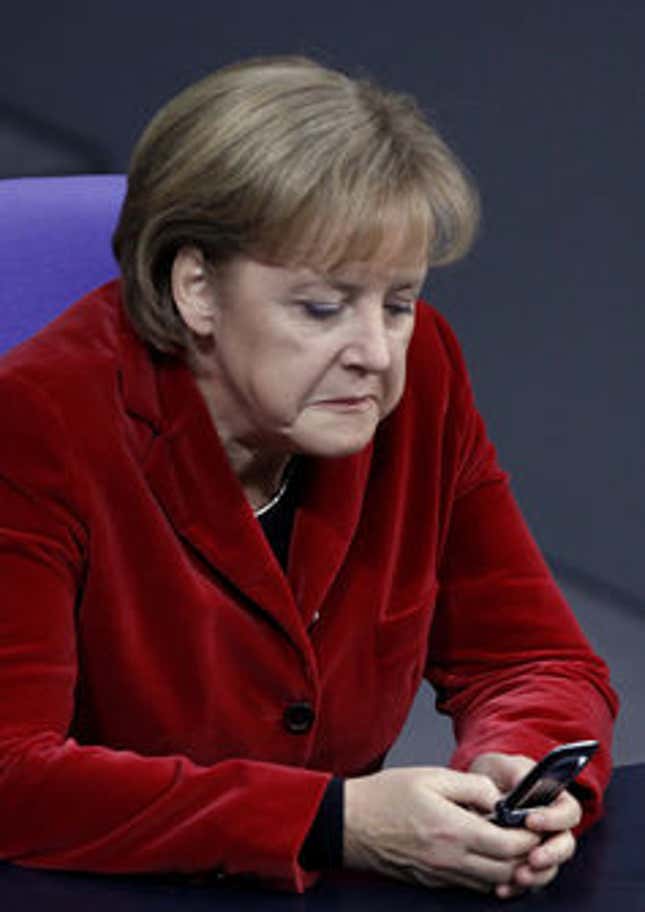 German Chancellor Angela Merkel texts on her ‘handy.’