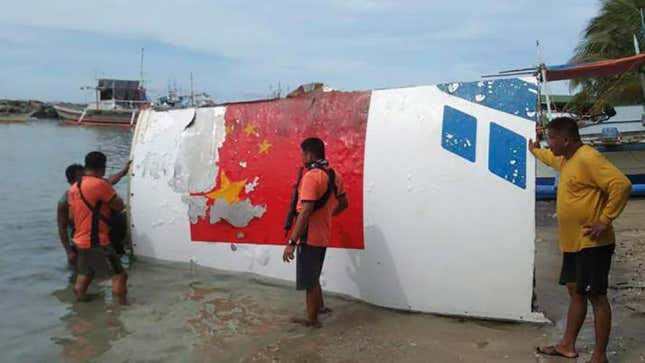 Rescuers recover debris, which the Philippine Space Agency said has markings of the Long March 5B (CZ-5B) Chinese rocket that was launched on July 24, after it was found in waters off Mamburao, Occidental Mindoro province, Philippines, on Aug. 2, 2022.