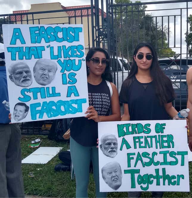Young protestors hold placards denouncing fascism outside the Howdy, Modi! event in Houston, Texas.