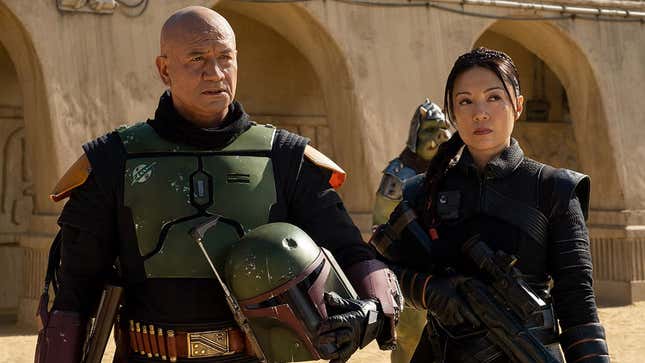 An image shows an older Bobba Fett and a woman standing together. 