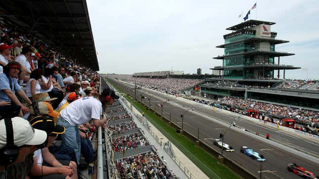 Cars stream by the front stretch of the Indianapolis Motor Speedway during the 500