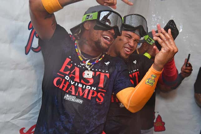 Sep 13, 2023; Philadelphia, Pennsylvania, USA; Atlanta Braves right fielder Ronald Acuna Jr. (13) and shortstop Orlando Arcia (11) celebrate their 6th straight National League East title in the locker room after win against the Philadelphia Phillies at Citizens Bank Park.