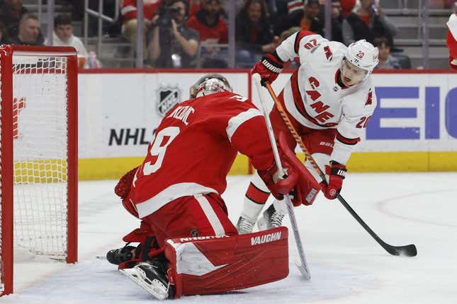 Mar 30, 2023; Detroit, Michigan, USA; Detroit Red Wings goaltender Alex Nedeljkovic (39) makes the save on Carolina Hurricanes center Sebastian Aho (20) in the first period at Little Caesars Arena.