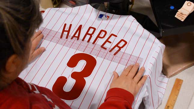 A jersey being lettered and prepared to send out to a Phillies fan.