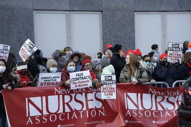Nurses gathered on the side of the street.
