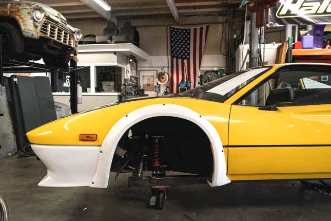 The nose of a highly modified yellow Ferrari 328 GTI 