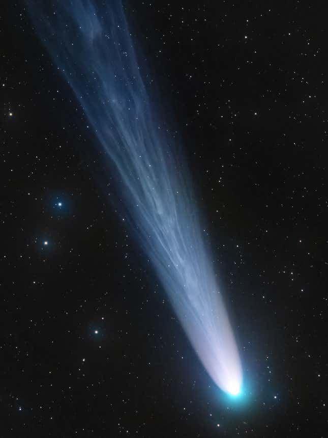 The bright blue comet Leonard leaving the Solar System.