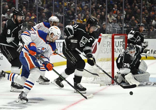 Apr 4, 2023; Los Angeles, California, USA; Los Angeles Kings center Anze Kopitar (11) clears the puck from in front of the net in the first period against the Edmonton Oilers at Crypto.com Arena.