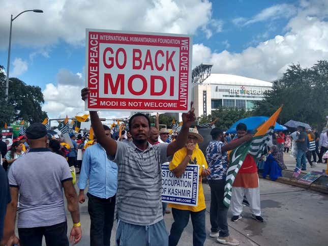 A protestor holds a placard that reads "Go back Modi" at the Howdy,Modi! event in Houston, Texas."