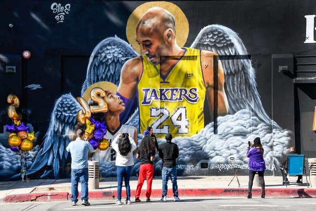 Jan 26, 2021; Los Angeles, California, USA; Fans gather at a mural of Kobe Bryant and his daughter Gianna painted on the wall of Hardcore Fitness Bootcamp gym in downtown Los Angeles. Bryant and his daughter and seven other persons died in a helicopter crash in Calabasas, Calif. on Jan. 26, 2020.