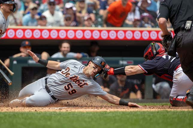 Jun 17, 2023; Minneapolis, Minnesota, USA; Detroit Tigers third baseman Zack Short (59) is tagged out at home plate by Minnesota Twins catcher Ryan Jeffers (27) during the fifth inning at Target Field.