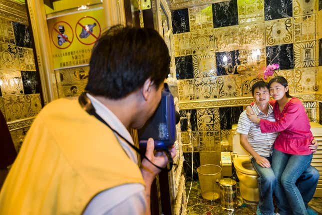 A 24-karat, solid-gold toilet at the 3D-Gold jewelry store, Hong Kong, 2005. The toilet, with a bowl encrusted in jewels, draws more than three thousand visitors a day, most from Mainland China, to be photographed sitting on it. The store’s owner, Sai-wing Lam, who grew up struggling as a fruit vendor during the Cultural Revolution, was inspired by Lenin’s dream of a Communist utopia where public toilets were made of gold.