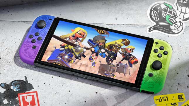 A Splatoon 3 special edition Switch OLED model sits on top of concrete. 